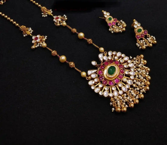 Ornate gold necklace and earrings set.